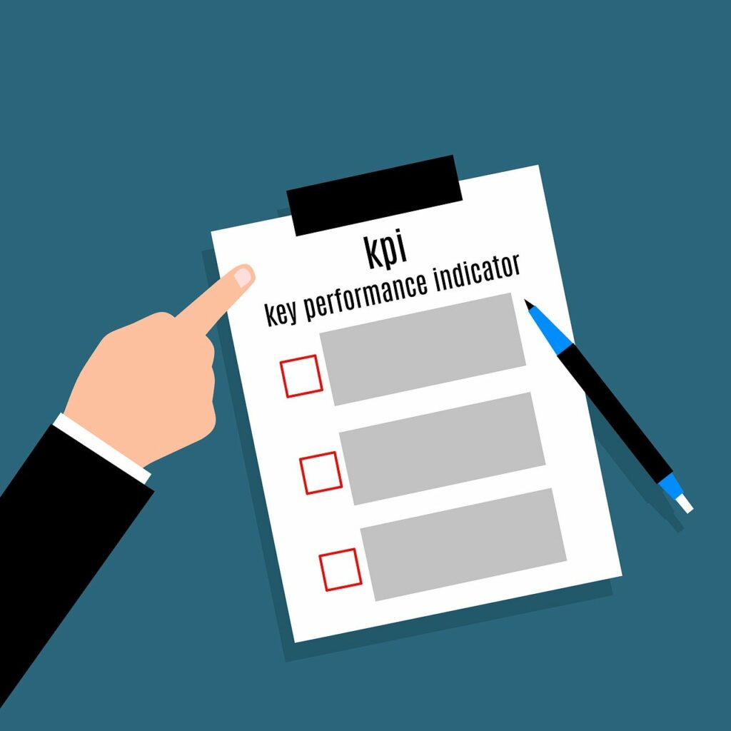 Cartoon drawing of a male hand pointing to a clipboard with a KPI worksheet.